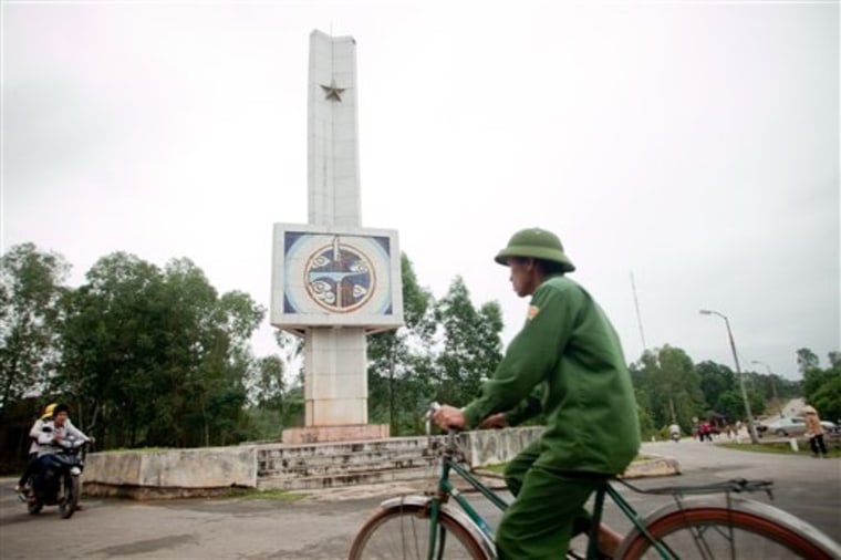 Riders pass the historic Dong Loc T-junction Monument, Ha Tinh Province, Vietnam on Tuesday. A poll shows the people of Vietnam rarely think about a conflict that still ignites political passions in the U.S.
